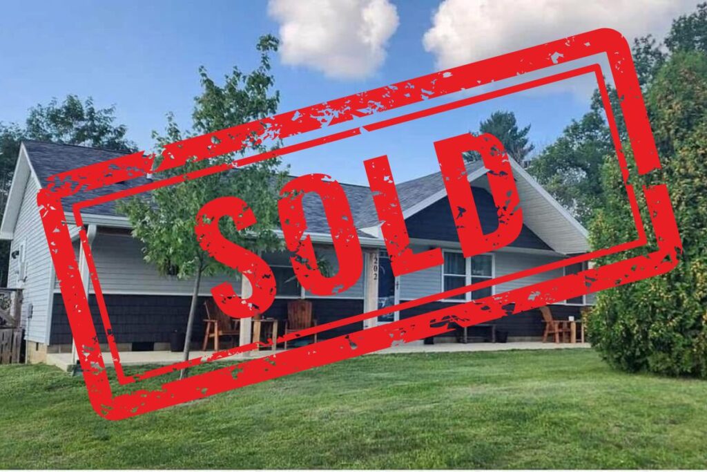 Image of home downsizing for empty nesters with text "sold" on it